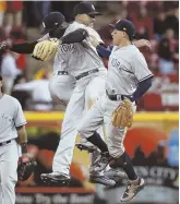  ?? AP PHOTO ?? CAN’T KEEP THEM DOWN: Yankees teammates Didi Gregorius, Starlin Castro (back) and Ronald Torreyes celebrate their victory against the Reds last night.