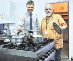  ??  ?? Catching Lives service manager Terry Gore, right, and Yorkshire Building Society’s Nick Austin with the new oven