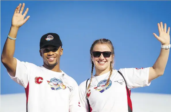  ?? LYLE ASPINALL/FILES ?? Olympic medallists Akeem Haynes and Erica Wiebe wave after disembarki­ng a Dreams Take Flight jet in Los Angeles last October. Haynes, who grew up poor before his big Olympic break, joined his hometown chapter of Dreams Take Fight Calgary for the trip...