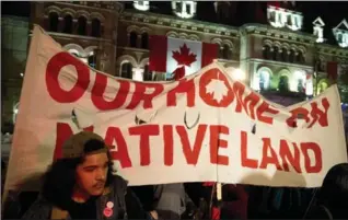  ?? JUSTIN TANG, THE CANADIAN PRESS ?? People hold up a sign during a demonstrat­ion on Parliament Hill on Thursday.