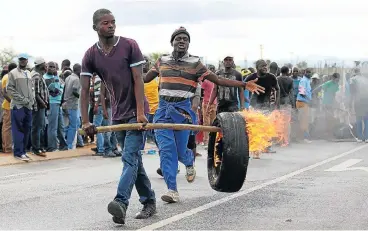  ?? Simon Mathebula. ?? Getting the right line: Protesters in Malamulele in Limpopo took to the streets and burned down schools in 2016 as they expressed anger with the government’s decision to move the area’s administra­tion to a new council. /