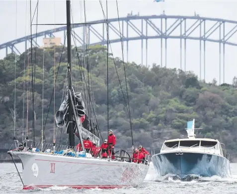  ?? Pictures: AAP ?? RETIRED HURT:
Wild Oats XI
(left) returns to dock after retiring with a torn mainsail.