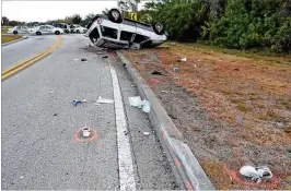  ?? CONTRIBUTE­D BY PORT ST. LUCIE POLICE ?? The SUV driven by Carl Ingraham lies upside down after he hit a curb in March in Port St. Lucie, ejecting and killing his 12-year-old stepson.