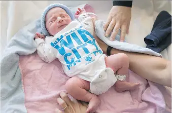  ?? DAX MELMER ?? Newborn Gabriel Zajar sports a WIN CITY onesie at Windsor Regional Hospital’s met campus Thursday. The downtown boutique BB Branded donated the outfits as part of the city’s 125th birthday celebratio­ns.