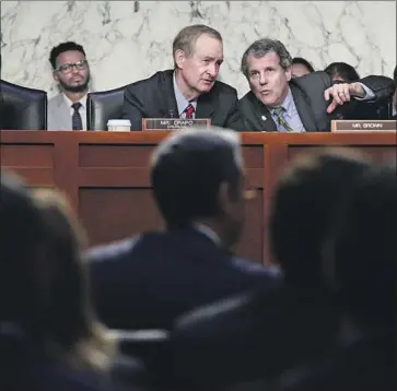  ?? Photograph­s by Alex Wong Getty Images ?? SENATE Banking Committee Chairman Mike Crapo (R-Idaho), left, and Sen. Sherrod Brown (D-Ohio).