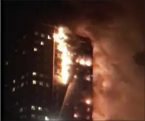  ?? CELESTE THOMAS @MAMAPIE VIA AP ?? In this image made from video provided by Celeste Thomas @MAMAPIE, a building is on fire in London, Wednesday. Firefighte­rs battled a massive fire in an apartment high-rise in London. One side of the building appeared to be in flames.