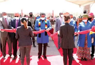  ??  ?? President Mnangagwa cuts the ribbon to mark the launch of Anjin Mining Company’s official resumption of work in Chiadzwa. He is flanked by Vice President Constantin­o Chiwenga (second from right), Defence and War Veterans Affairs Minister Oppah Muchinguri-Kashiri (right), Anjin board chairman Mr Jiang Qingde (second from left) and Minister of Finance Mthuli Ncube (left). — Picture: Tinai Nyadzayo