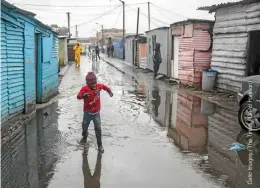  ??  ?? Better access to basic services: Informal settlement in Langa, Cape Town