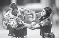  ?? REUTERS ?? Malcolm Marx of South Africa's Lions fends off Matt Todd of the Canterbury Crusaders during Saturday’s Super Rugby Final in Christchur­ch, New Zealand.