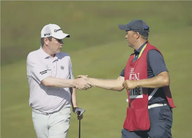  ??  ?? 0 Bob Macintyre with his caddie Mike Thomson on the 18th hole during the final day of the Open at Royal St George’s on Sunday