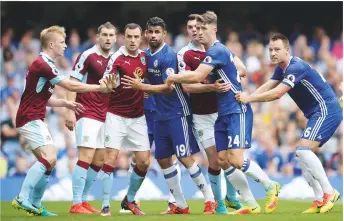  ??  ?? Free-for-all...Burnley (in claret) and Chelsea players get to grips with one another ahead of an incoming corner