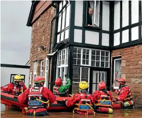  ?? PA/AP ?? A Mountain Rescue team prepares to rescue a man from his house after flooding caused by Storm Dennis inundated Monmouth, Wales.