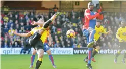  ??  ?? WATFORD: Watford’s French midfielder Younes Kaboul (L) clears the ball under pressure from Crystal Palace’s Zaire-born Belgian striker Christian Benteke during the English Premier League football match between Watford and Crystal Palace at Vicarage...