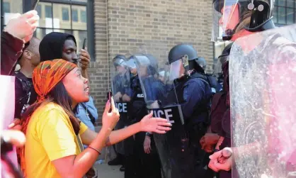  ??  ?? Protesters confront police during demonstrat­ions in St Louis, Missouri following the acquittal of a white former St. Louis police officer, who was charged with first-degree murder in the shooting death of black motorist Anthony Lamar Smith in 2011....