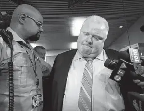  ?? AP/CHRIS YOUNG ?? Toronto Mayor Rob Ford makes a statement to the media outside his office at Toronto’s City Hall after the release of a video Thursday.