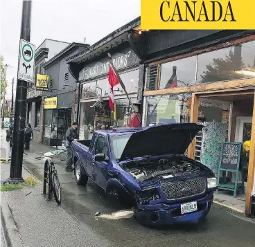  ?? RUFUS DRUM SHOP / INSTAGRAM ?? A blue truck with Oregon plates sits wrecked after hitting a Vancouver storefront, after speeding through the Peace Arch border crossing and driving for 45 minutes unimpeded.