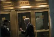  ?? MARY ALTAFFER — THE ASSOCIATED PRESS FILE ?? A trader speaks to a security guard as he leaves the New York Stock Exchange in lower Manhattan.