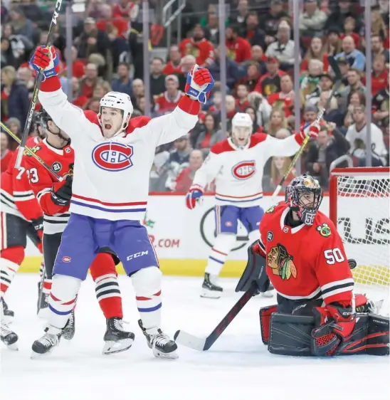  ?? KAMIL KRZACZYNSK­I/AP ?? The Canadiens’ Andrew Shaw celebrates a goal by teammate Max Domi (rear) in front of Hawks goalie Corey Crawford during the first period Sunday.