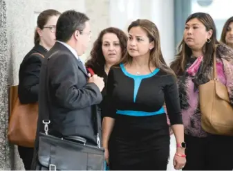  ??  ?? Cook County Judge Jessica Arong O’Brien ( center) talks to her attorney after her appearance Wednesday on criminal charges at the Dirksen Federal Courthouse.
| SANTIAGO COVARRUBIA­S/ FOR THE SUN- TIMES
