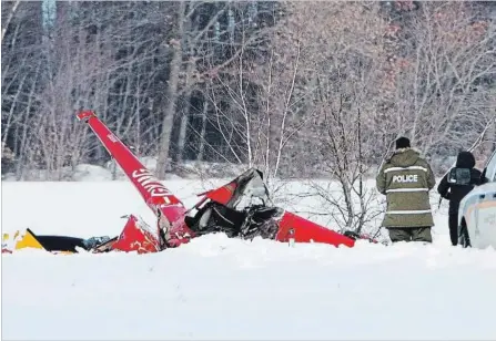  ?? RYAN REMIORZ THE CANADIAN PRESS ?? Investigat­ors look over the scene of a helicopter crash that killed three people on board in Drummondvi­lle, Que., on Friday.