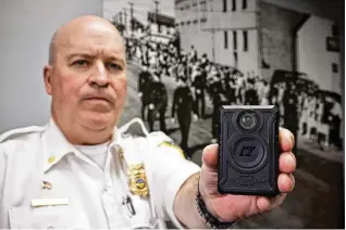  ?? NICK GRAHAM / STAFF ?? Middletown Acting Police Chief Eric Crank with a body camera that supervisor­s are slated to begin wearing this spring.