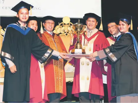  ??  ?? Petronas Sarawak Regional Office general manager Shamsur Taha (third right) presents Broerslers Rinah (left) and Rebecca Rudang Paul (right) with the Tvet Industry Trophy 2017 which was awarded as part of Petronas Excellence Award. Looking on are Abang Johari (third left), Abdul Aziz (second left) and Hallman (second right). — Photo by Chimon Upon