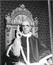  ?? AP PHOTO ?? Pope Pius XII, wearing the ring of St. Peter, raises his right hand in a papal blessing in September 1945 at the Vatican.