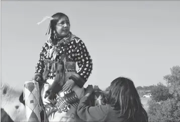  ?? ASSOCIATED PRESS ?? IN THIS AUG. 18 PHOTO, JULIA BRIEN, LEFT, prepares for the Crow Fair parade in Crow Agency, Mont. For the Crow Tribe, the eclipse coincides with the Parade Dance at the annual Crow Fair, marking the tribe’s new year.