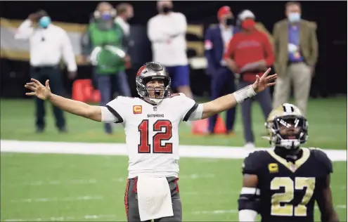  ?? Chris Graythen / Getty Images ?? The Buccaneers’ Tom Brady celebrates a first down against the Saints late in the fourth quarter in a divisional round playoff game on Sunday in New Orleans.