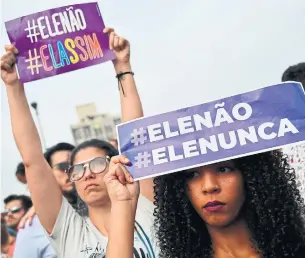  ?? NELSON ALMEIDA AFP/GETTY IMAGES ?? Women hold signs saying “Not him” and “Never him” in protest of right-wing presidenti­al candidate Jair Bolsonaro in Sao Paulo. Bolsonaro’s campaign has exposed deep divisions in Brazil.