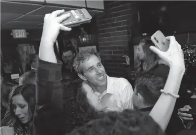  ?? Associated Press ?? ■ Democratic presidenti­al candidate Beto O'Rourke takes selfies with supporters Monday after speaking at Gino's Cento Anno in Cleveland.