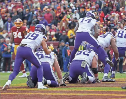  ??  ?? Vikings wide receiver Adam Thielen (19) celebrates with teammates in the end zone by simulating hopscotch after scoring a touchdown against the Redskins in the second quarter. GEOFF BURKE/USA TODAY SPORTS