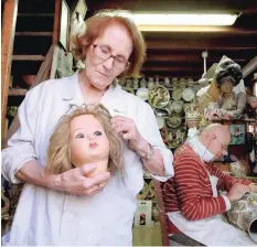  ??  ?? Federico Squatriti and his mother Gesolmina work in their 15-square-metre Doll Hospital workshop along Via di Ripetta in Rome, which is packed with parts of antique dolls, toy soldiers, puppets and ceramics figurines. — AFP file photo