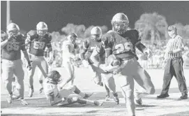  ?? JIM RASSOL/STAFF WRITER ?? Devonta’e Henry-Cole scores a touchdown to put St. Thomas ahead, 14-0, over Booker T. Washington on Friday night at Brian Piccolo Stadium.