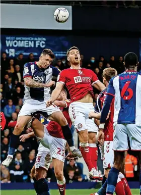  ?? ?? Bristol City’s Chris Martin has an aerial battle with Jordan Hugill