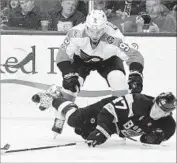  ?? Michael Dwyer Associated Press ?? BOSTON’S TOREY KRUG hits the ice in front of Philadelph­ia’s Ivan Provorov in the second period.