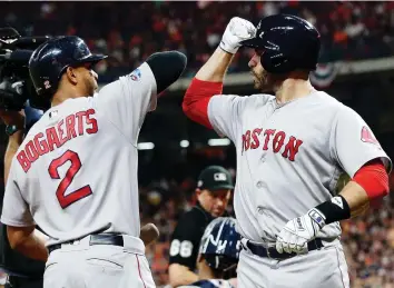  ?? FRaNK FRaNKLIN II/THE ASSOCIATED PRESS ?? Red Sox designated hitter J.D. Martinez, right, celebrates his homer with Xander Bogaerts on Thursday during Game 5 of their American League Championsh­ip Series against the Astros in Houston as Boston won 4-1 to advance to the World Series for the first time since 2013.