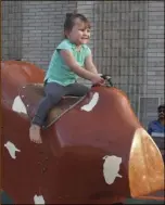  ?? PHOTO TOM BODUS ?? Kathryn Whittemore, 3, tames the mechanical bull at Sunday night’s Celebrate Light event at First Christian Church of El Centro.