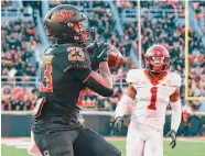  ?? Brody Schmidt/Associated Press ?? Iowa State’s Anthony Johnson Jr. can only watch as Oklahoma State running back Jaden Nixon catches the winning touchdown Saturday in Stillwater, Okla.