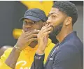  ?? DAMIAN DOVARGANES/ASSOCIATED PRESS ?? Lakers LeBron James, left, and Anthony Davis share a moment after Davis was formally introduced as a teammate Saturday in El Segundo, Calif.