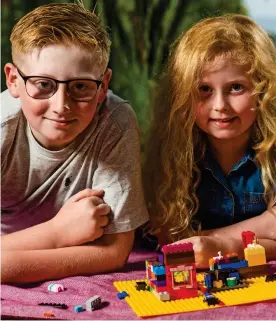  ??  ?? Big brother: Harrison Walmsley with six-year-old Eva and Lego set