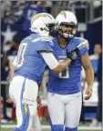  ??  ?? Los Angeles Chargers’ Kellen Clemens (left) and Drew Kaser (right) celebrate an extra point kicked by Kaser in the second half of an NFL football game against the Dallas Cowboys on Thursday in Arlington, Texas. AP PHOTO/MICHAEL AINSWORTH