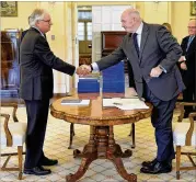  ?? JEREMY PIPER / AUSTRALIAN GOVERNMENT ROYAL COMMISSION ?? Justice Peter McClellan (left) shakes hands Friday with Governor-General of Australia Peter Cosgrove at the release of the final report of the Royal Commission into child sexual abuse.