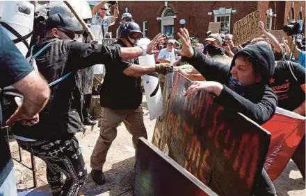  ?? AGENCY PIX ?? White supremacis­ts clashing with counter protesters at a rally in Charlottes­ville, Virginia, on Saturday.