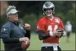  ?? MATT ROURKE — THE ASSOCIATED PRESS ?? Philadelph­ia Eagles quarterbac­k Carson Wentz and coach Doug Pederson talk during practice at the team’s training facility last week in Philadelph­ia. Wentz is one of several key players who missed Philadelph­ia’s playoff run and are returning from injuries.