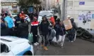  ?? Photograph: Alain Robert/Sipa/Rex/Shuttersto­ck ?? Residents accompanie­d by police and firefighte­rs recover their belongings from thecollaps­ed buildings.