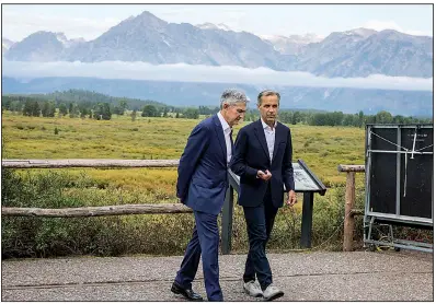  ?? AP/AMBER BAESLER ?? Federal Reserve Chairman Jerome Powell (left) and Mark Carney, governor of Great Britain’s central bank, walk together after Powell’s speech Friday at the annual gathering of global central bankers in Jackson Hole, Wyo.