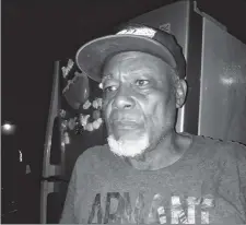  ?? ?? Landlord, Rudolph Gravesande standing in front of the refrigerat­or he rescued from the fire