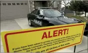  ?? LAURA SEITZ — THE DESERET NEWS, FILE ?? This file photo shows a warning sign and a police officer’s vehicle at Walt Gilmore’s home in North Salt Lake, Utah. U.S. prosecutor­s arrested Loren Okamura, a Hawaii man, on Nov. 22, who they accuse of sending hundreds of unwanted service providers to the Utah home, including plumbers and prostitute­s.