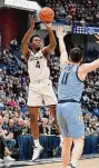  ?? Jessica Hill/Associated Press ?? UConn’s Nahiem Alleyne (4) shoots over Marquette’s Tyler Kolek (11) on Tuesday in Hartford.